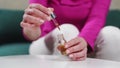 Close up woman hands with glass droplet bottle of essential oils. Wellness natural remedies.