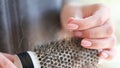 Close up of woman hands hold comb with a lot of hair. Royalty Free Stock Photo