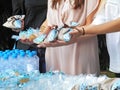 Woman hands holding baptism favors at a greek Orthodox christening