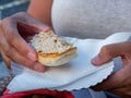 Close up of woman hands holding a bun with pork cerebellum