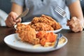 Close-up woman hands holding cutting fried. Royalty Free Stock Photo