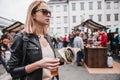 Close up of woman hands holding delicious organic salmon vegetarian burger and homebrewed IPA beer on open air beer an