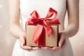 close up of woman hands holding a gift box with red ribbon. Royalty Free Stock Photo