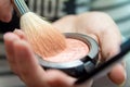 Close up of woman hands holding makeup brush and blush box Royalty Free Stock Photo