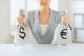 Close up of woman hands holding money bags Royalty Free Stock Photo