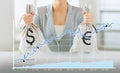 Close up of woman hands holding money bags Royalty Free Stock Photo