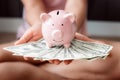 Close-Up Woman Hands is Holding Money Cash and Piggy Bank in Her Bedroom, Pink Piggy Saving, Business Banking and Financial Royalty Free Stock Photo