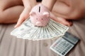 Close-Up Woman Hands is Holding Money Cash and Piggy Bank in Her Bedroom, Pink Piggy Saving, Business Banking and Financial Royalty Free Stock Photo