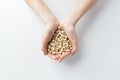 Close up of woman hands holding peeled peanuts