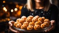 Close-up of a woman hands holding pumpkin cookies, ideal for illustrating festive baking or Halloween treats