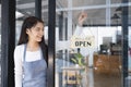 Close up of woman hands holding sign now we are open support local business. Royalty Free Stock Photo