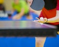 Close up of a woman hands holding table tennis rocket and ball