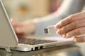 Woman holding usb flash drive next to laptop at home Royalty Free Stock Photo