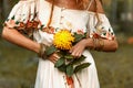 Close up of woman hands holding yeloow flower outdoors