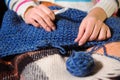 Close-up of woman hands knitting colorful wool yarn. Royalty Free Stock Photo