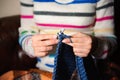 Close-up of woman hands knitting colorful wool yarn. Royalty Free Stock Photo