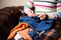 Close-up of woman hands knitting colorful wool yarn. Royalty Free Stock Photo