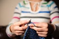 Close-up of woman hands knitting colorful wool yarn. Royalty Free Stock Photo