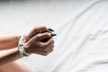 Close-up woman hands with long green glitter nails tied up with rope. Ideas to stop violence against women, sexual harassment. Royalty Free Stock Photo