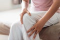 Close-Up of Woman Hands is Massaging Her Knee on a Bedroom., Healthcare and Medicine Concept Royalty Free Stock Photo