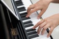 Close up of woman hands playing piano background Royalty Free Stock Photo