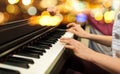 Close up of woman hands playing piano over lights Royalty Free Stock Photo