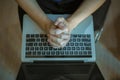 Close up of woman hands pray on laptop, Praying for works