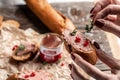 Close up Woman hands preparing and eating gourmet Belgian duck liver pate bread. Fresh homemade chicken liver pate on toasted