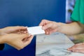 Close up woman hands reciving white plastic card Royalty Free Stock Photo