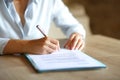 Close up of woman hands signing contract on table Royalty Free Stock Photo