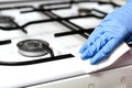 Close-up of  woman hands with surgical gloves cleaning the coocking stove  of grease and dirt Royalty Free Stock Photo