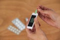 Close-up of woman hands testing blood sugar with glucometer