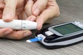 Close-up Of Woman Hands Testing High Blood Sugar With Glucometer.