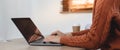 Close up of woman hands typing on laptop computer keyboard on table at home Royalty Free Stock Photo