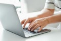 Close up of woman hands typing on laptop keyboard on the table at home office or workplace Royalty Free Stock Photo