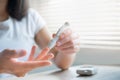 Woman testing blood sugar level