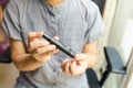 Close up of woman hands using lancet on finger to check blood sugar level by Glucose meter. Use as Medicine, diabetes, glycemia, Royalty Free Stock Photo