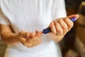 Close up of woman hands using lancet on finger to check blood sugar level by Glucose meter. Use as Medicine, diabetes, glycemia, Royalty Free Stock Photo