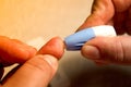 Close up of woman hands using lancet on finger to check HIV status. Blue lancet. Hiv test express Royalty Free Stock Photo