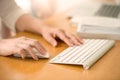 Close up of woman hands using mouse and keyboard.