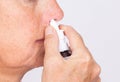 Close up of woman hands using nasal spray Royalty Free Stock Photo