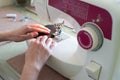 Close-up woman hands using sewing machine to sew black cotton face medical mask. DIY or individual protect on quarantine concept. Royalty Free Stock Photo
