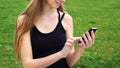 Close-up woman hands using touchscreen phone outdoors in city park Royalty Free Stock Photo
