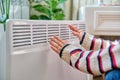 Close-up of woman hands warming near electric heating radiator Royalty Free Stock Photo