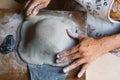 Close up of woman hands working clay making pottery at home. Concept of hobby and creativity at home. Kneading and moistening the Royalty Free Stock Photo