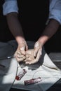 Close up of woman hands works with clay. Female potter kneads and moistens the clay before work. Royalty Free Stock Photo