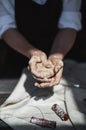 Close up of woman hands works with clay. Female potter kneads and moistens the clay before work. Royalty Free Stock Photo