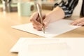 Woman hands writing letter sitting on a desk Royalty Free Stock Photo