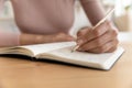 Close up of woman handwrite in notebook