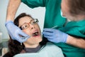 Close up of woman having dental check up in dental office. Dentist examining a patient`s teeth with dental Royalty Free Stock Photo